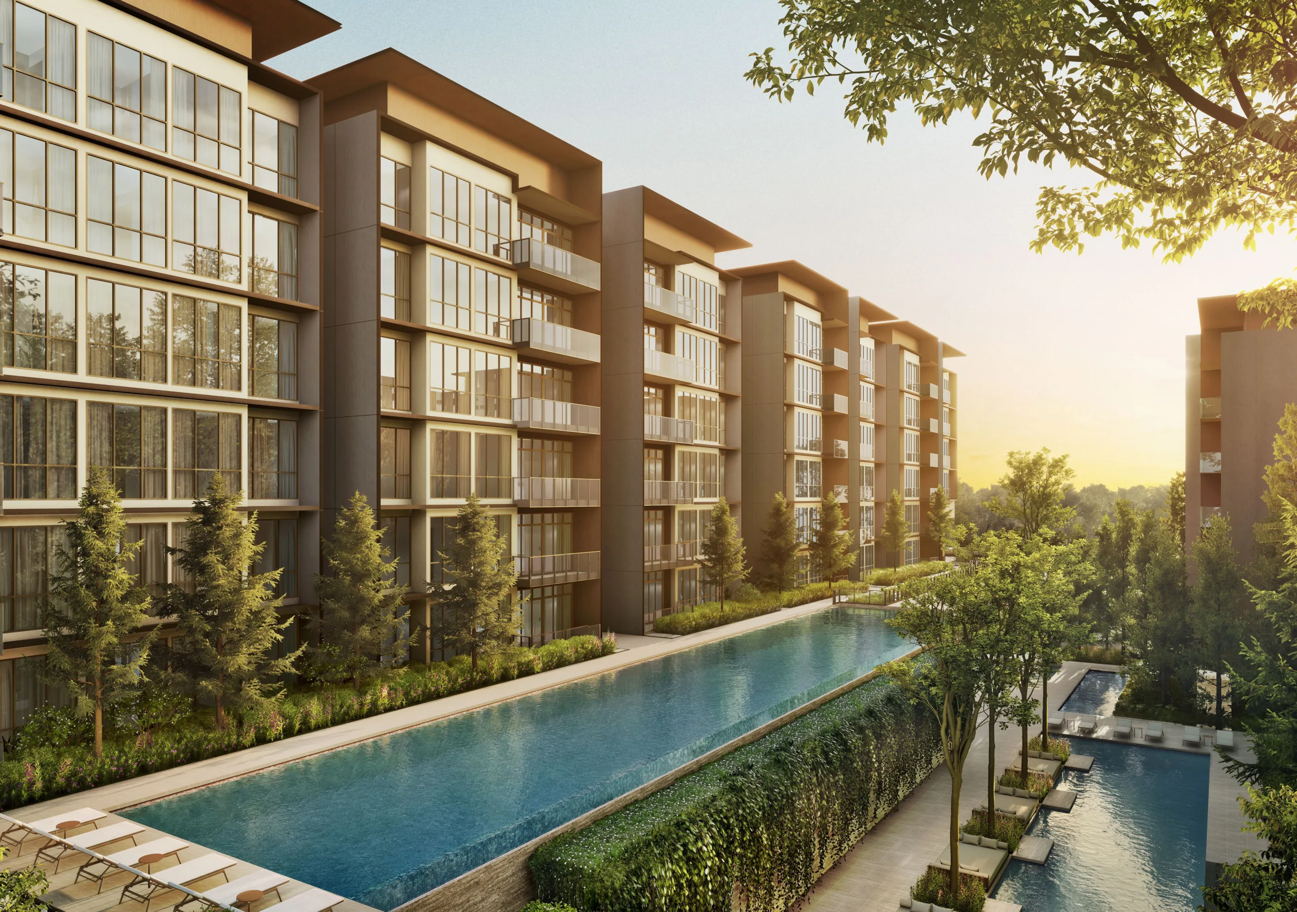 A long lap pool running beside the residential blocks at sunset